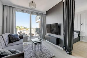 Televízia a/alebo spoločenská miestnosť v ubytovaní Grand Apartments Chlebova