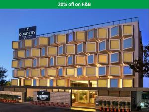 a rendering of a building with yellow windows at Country Inn & Suites By Radisson, Bengaluru Hebbal Road in Bangalore