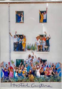 a group of people posing for a picture on a wall at Hostal Cristina in Cadaqués