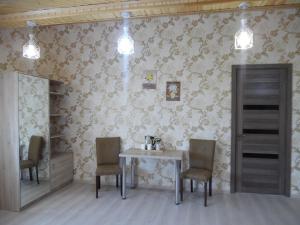 a dining room with a table and two chairs at Guest House Tamta in Stepantsminda