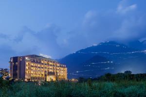 a building on a hill with a mountain in the background at Welcomhotel By ITC Hotels, Katra in Katra