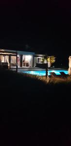 a night view of a house with a swimming pool at Villa Melody Novalja in Novalja