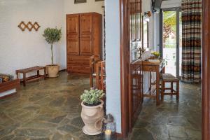 a room with a counter and a table with a plant at Flamingos Hotel Apartments in Kato Daratso