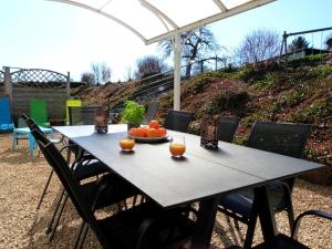 een tafel met een kom sinaasappels erop bij Les Gîtes du Rancourt - Sous la Grange & Le Logis in Sainte-Ode