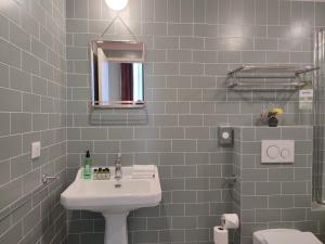 a bathroom with a sink and a mirror at Aparthotel AMMI Vieux Nice in Nice