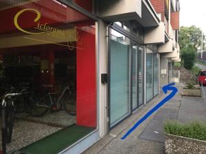 a door to a store with a blue line on the sidewalk at Lugano 33A - No Bikes - Self check-in - no reception in Lugano