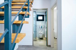 a bathroom with a stairs leading to a toilet at Ilias Suites in Skala Potamias +44 photos