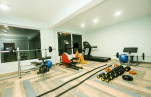 a gym with weights and equipment in a room at Hotel Smugglers Mountain View - central heated & air Cooled in Manāli