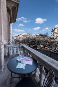 a table and chairs on a balcony with a view at Budapest Easy Flat Oktogon in Budapest