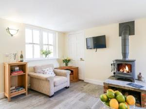 a living room with a fireplace and a chair at The Big Splash in Lincoln