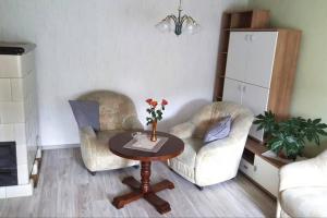 ein Wohnzimmer mit 2 Stühlen und einem Tisch in der Unterkunft Sonnenblick Rittersgrün II in Breitenbrunn