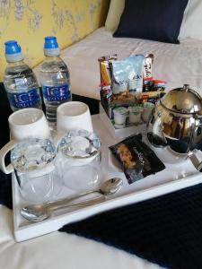 a tray with a tea set on a bed at Park Top House in Haworth