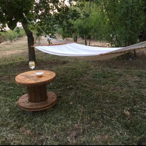 a hammock hanging from a tree next to a table at Villa Calcerame in Montelepre