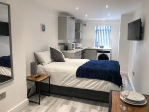 um pequeno quarto com uma cama e uma cozinha em 10min to City - FREE Parking - Private Studio - Contractor Friendly em Manchester