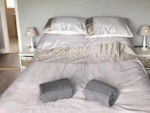a large white bed with two pillows on it at Inviting 2-Bed Bungalow in Heacham with spa bath in Heacham