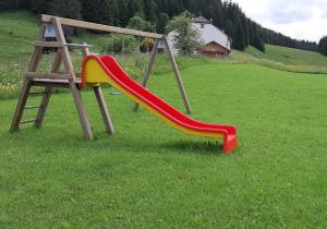 a playground with a slide in a field at L étincelle du Manon in Lajoux