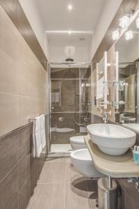 bagno con 2 servizi igienici, lavandino e doccia di Penta Luxury House a Roma