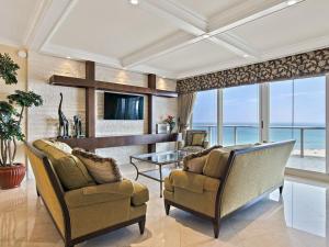 a living room with two chairs and a table at Ritz Carlton Luxurious Residence on Singer Island in Riviera Beach