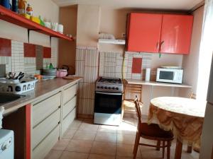 a small kitchen with a table and a stove at Bella Vendégház in Székesfehérvár