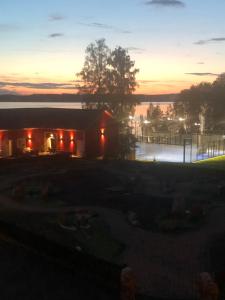 a house with a sunset in the background at Frykenbadens Camping & Resort in Kil