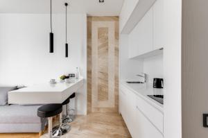 a white kitchen with a sink and a counter at BASIS APARTMENTS - Adults Only in Kyiv