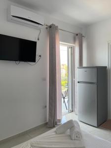 a living room with a tv on a wall at Villa Angelina Ksamil in Ksamil
