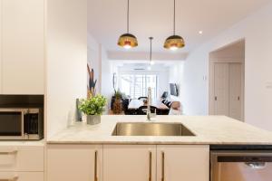 a kitchen with a sink and a counter top at Hip, Stylish Apartment in Little Italy by Den Stays A in Montréal