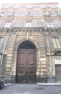 a building with a large door with graffiti on it at Valina Apartments in Catania