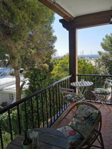 a porch with a chair on a balcony with a view at APARTAMENTO PORT DE RODA DE BARA -ROC SANT GAIETA in Roda de Bará