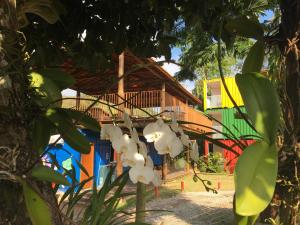 a house with white flowers in front of it at Trakai Suites in Ubatuba