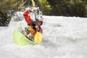 a man is on a raft in the water at Ferienwohnung Hain in Birnbaum