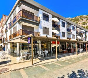 a building with tables and chairs in front of it at Luff Suites in Kaş