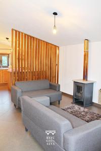 a living room with a couch and a fireplace at Refúgio do Alva - Serra da Estrela in Seia