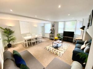a living room with a couch and a table at South cliff Apartment with Garden in Scarborough