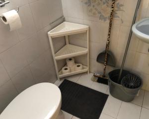 a white bathroom with a toilet and a sink at APARTMAN 4. in Balatonalmádi +6 photos