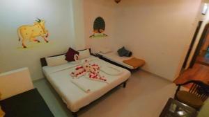 a room with two beds and a cow on the wall at The Royal Lake View Villa in Udaipur