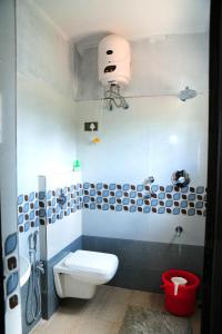a bathroom with a white toilet and a sink at DELIGHTFUL HOMESTAY in Sollebail