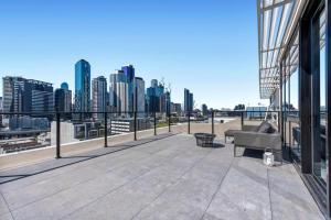 a balcony of a building with a view of a city at Luxury Penthouse with Astonishing Bay and City Views in Melbourne