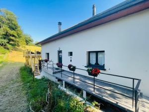 Un bâtiment blanc avec des fleurs sur son côté dans l'établissement Le Lodge du Pichat, à Sainte-Hélène-du-Lac