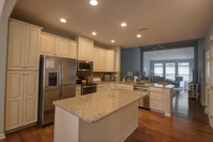 a kitchen with white cabinets and a granite counter top at 36528 Putter Ln, Frankford in Frankford