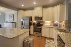 a kitchen with white cabinets and stainless steel appliances at 36528 Putter Ln, Frankford in Frankford +42 photos