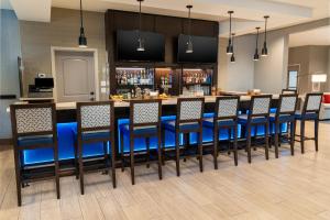 a bar with blue bar stools in a restaurant at Staybridge Suites - Nashville - Vanderbilt, an IHG Hotel in Nashville