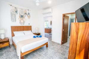 a bedroom with a bed and a flat screen tv at Viajero Sayulita Hostel in Sayulita
