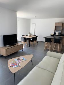 ein Wohnzimmer mit einem Sofa und einem Tisch in der Unterkunft Ô Pure in Annecy