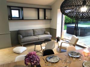 a living room with a table and a couch at le penty plougonvelin in Plougonvelin