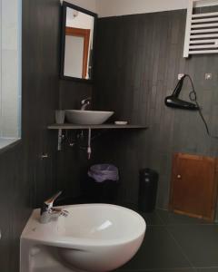 a bathroom with a white sink and a mirror at Al Castello in Morano Calabro +40 photos