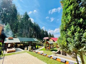 a resort with a train station and trees at Boutique Hotel Casa Emil in Poiana Brasov