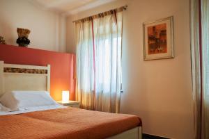 A bed or beds in a room at Affittacamere La Piazzetta