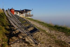a row of chairs sitting on the side of a hill at Rifugio Chierego - 1911m in Brenzone sul Garda