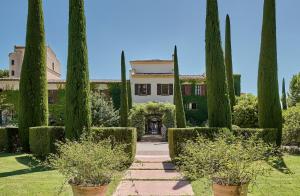 a row of trees in front of a house at Ch&acirc;teau Saint-Martin & Spa - an Oetker Collection Hotel in Vence